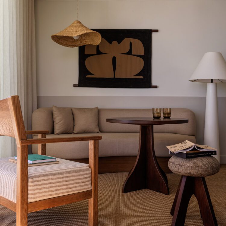 Sitting area with warm neutral furniture and sculptural wooden furniture