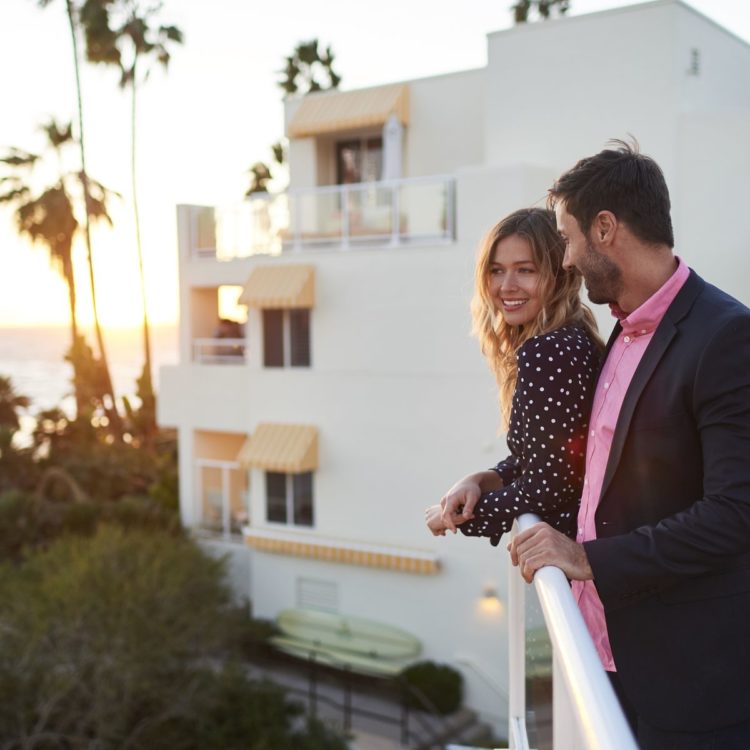 Man and woman stood on a balcony
