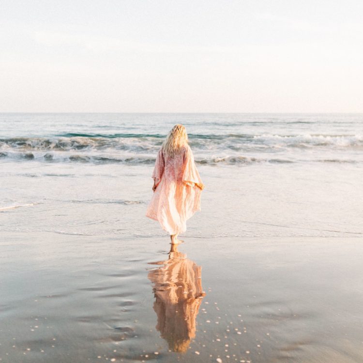 Woman on the beach, looking to the sea